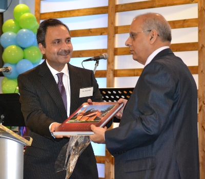 The Pakistani Consul-general in Vancouver, Shujah Alam (left) presenting a book featuring churches in Pakistan to Balbir Sheena of the Punjabi Masihi pastoral team.